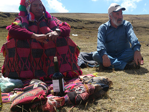 A person and person sitting on the ground  Description automatically generated